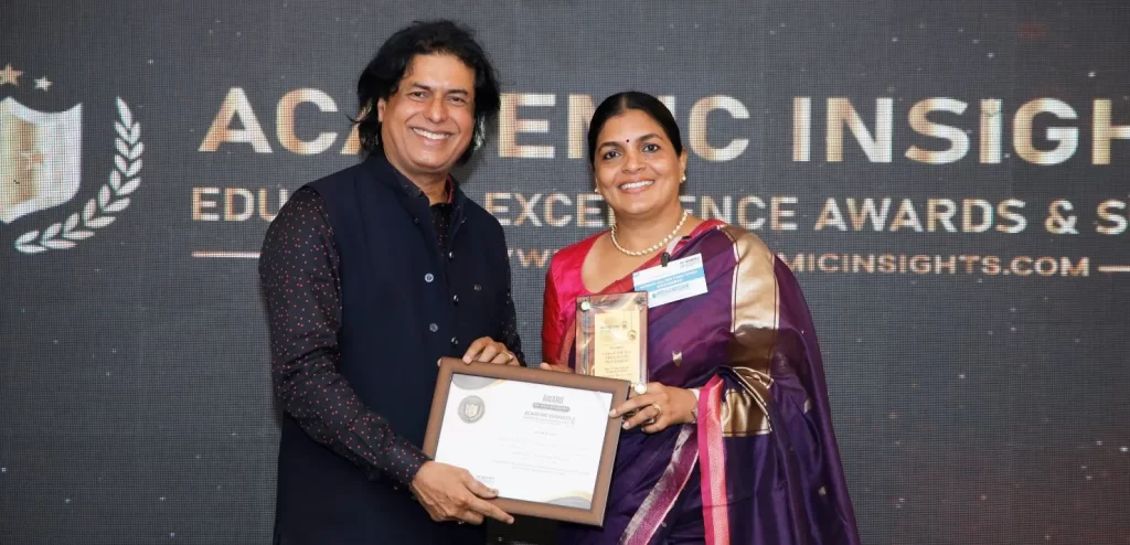 Ms. Liju P. Alex, Principal of National Hill View Public School, Banashankari receiving the award at the Academic Insights Education Excellence Awards and Summit 2024
