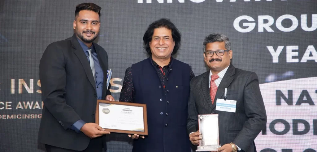 Mr. Rahidh A W, the Outreach Manager and Mr Ramesh Chandran, the Coordinator at National Model Sr Sec School receiving the award at the Academic Insights Education Excellence Awards & Summit 2024