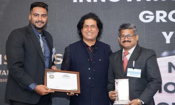 Mr. Rahidh A W, the Outreach Manager and Mr Ramesh Chandran, the Coordinator at National Model Sr Sec School receiving the award at the Academic Insights Education Excellence Awards & Summit 2024
