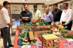 image of ceo of Thakur School of Architecture & Planning looking at a scale model