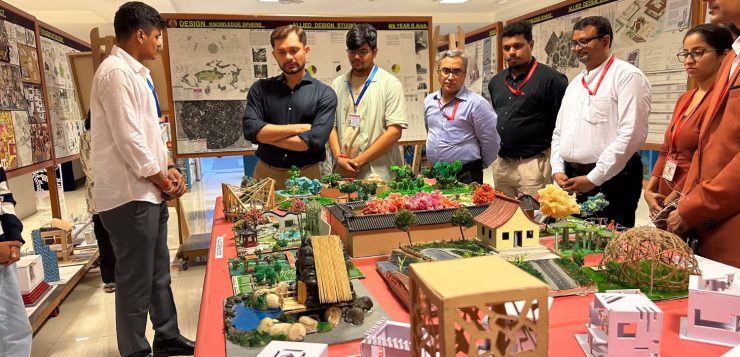 image of ceo of Thakur School of Architecture & Planning looking at a scale model