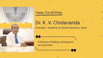 Dr. K. V. Chidananda, President of the Academy of Liberal Education, Sullia, seated at his desk in a white shirt and blue tie, with the text “Happy 71st Birthday” on a yellow background.